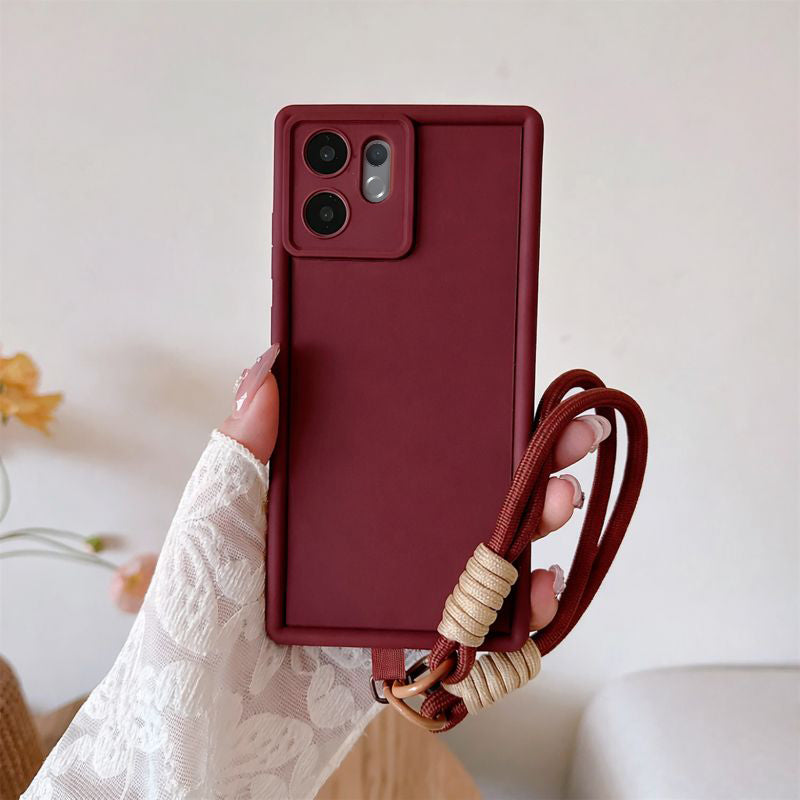 Maroon phone case with a strap held by a hand against a light background